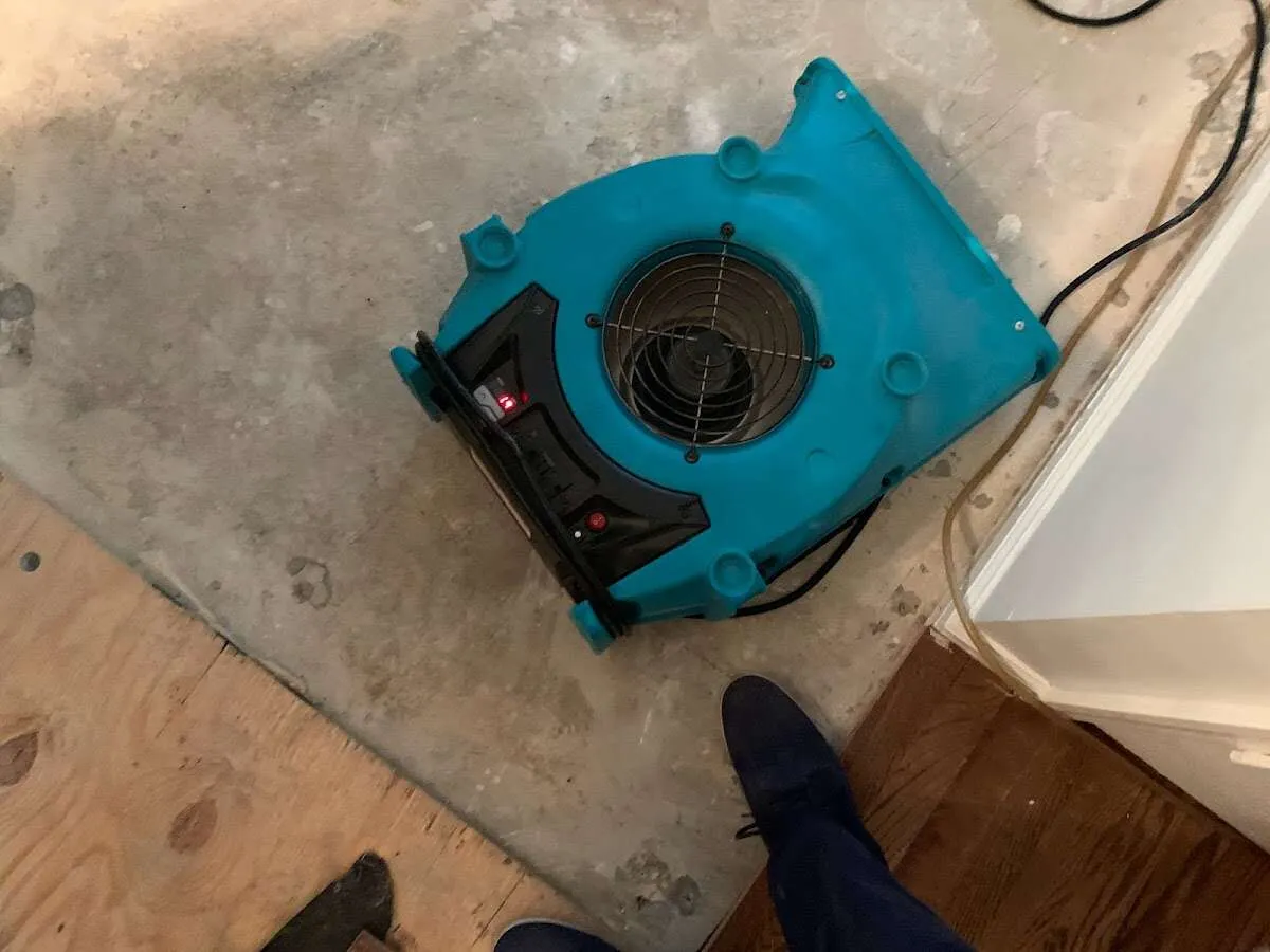 Air mover drying subfloor during Commercial Water Damage Restoration in East Rochester